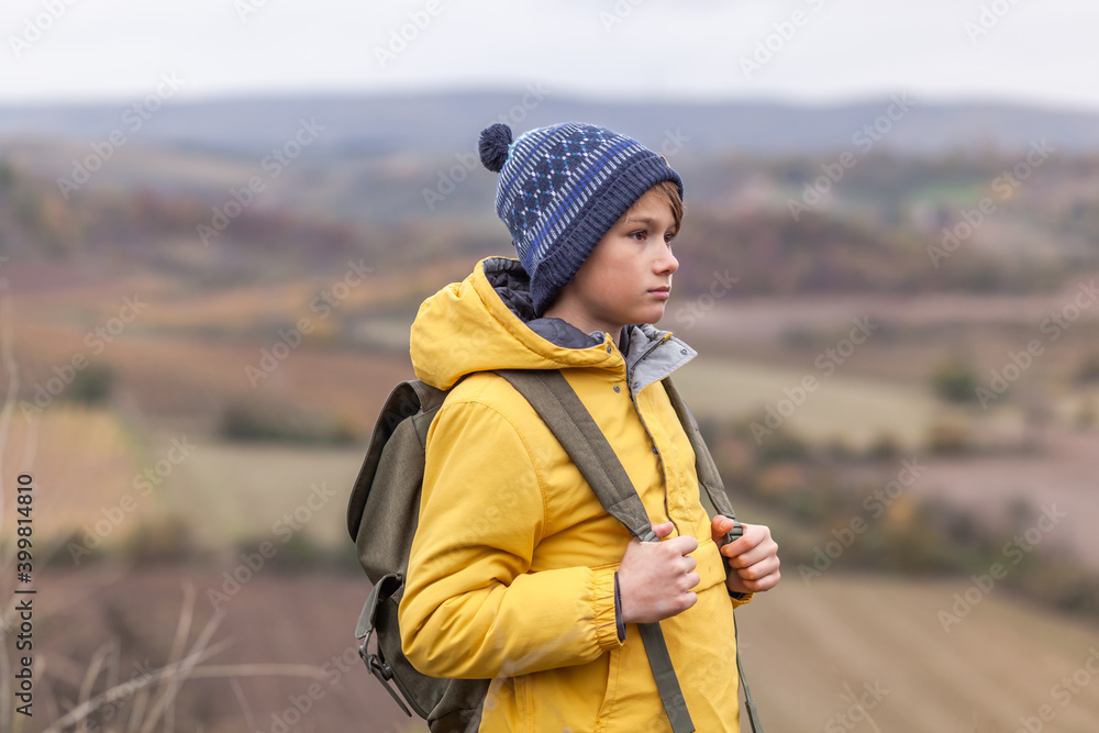 Pensive little hiker during autumn day on a hill. Pensive little hiker during autumn day on a hill.