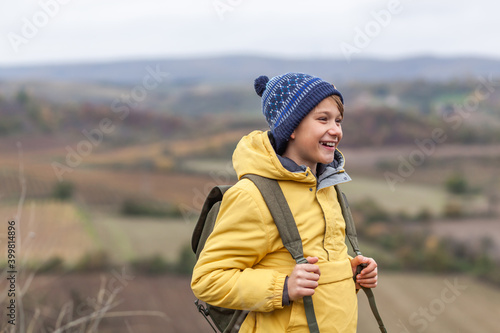 Happy little boy during autumn day on a hill.