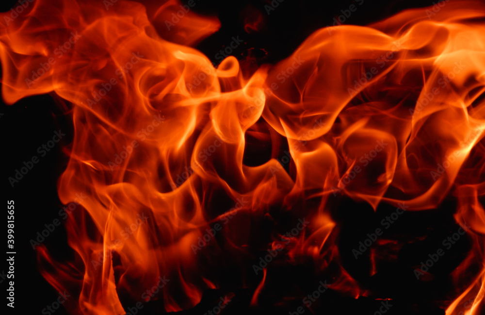 Abstract fire flame in fireplace, texture for background. Beautiful bright orange flames flicker in the darkness of the night. Abstract fire flame in fireplace, texture for background. Beautiful bright orange flames flicker in the darkness of the night.
