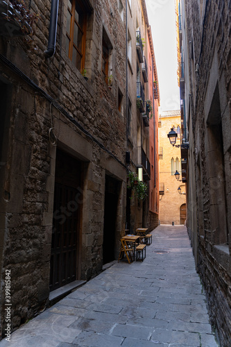 Cafe with terrace on a narrow street with medieval historic houses in Barcelona © pavelgulea