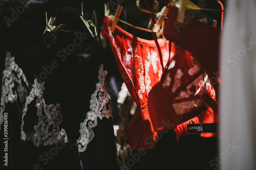 Different bra and panties on pink background. Colorful women sexy underwear. Top view, flat lay. Female wardrobe, shopping concept. Fashion lace lingerie. Black and beige. Big choice of gorgeous bras