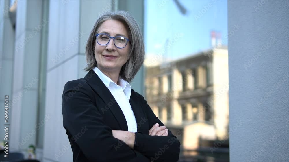 Mature elegant woman psychologist looking at camera suggesting her consultation
