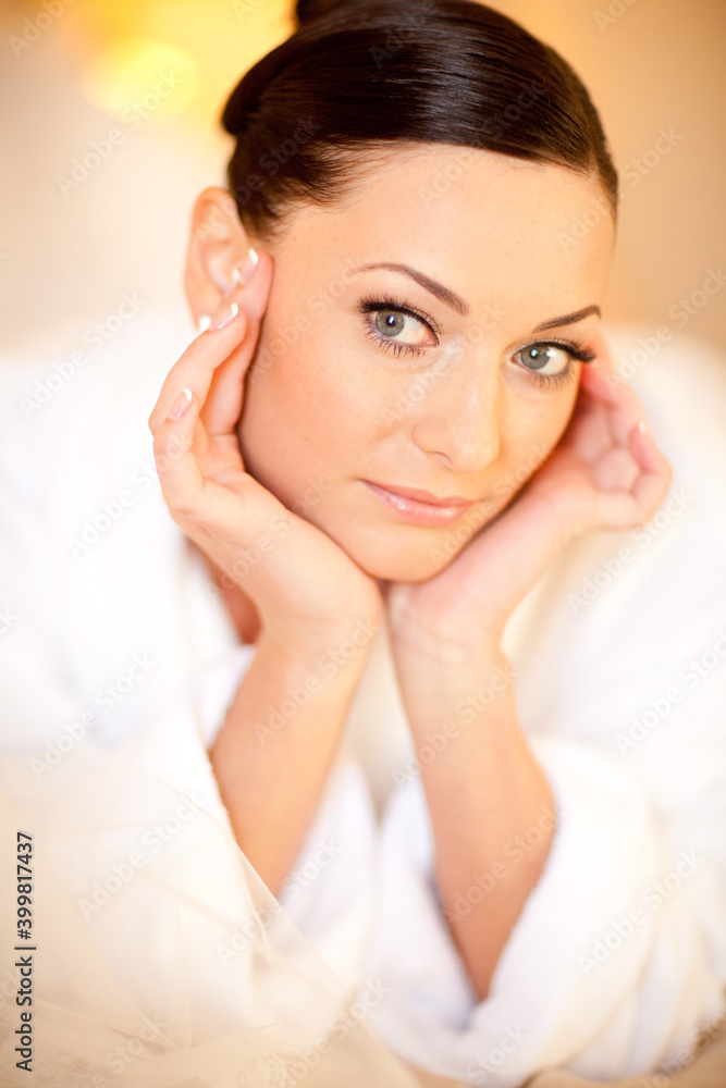 Beautiful girl in a white terry dressing gown in interior Beautiful girl in a white terry dressing gown in interior