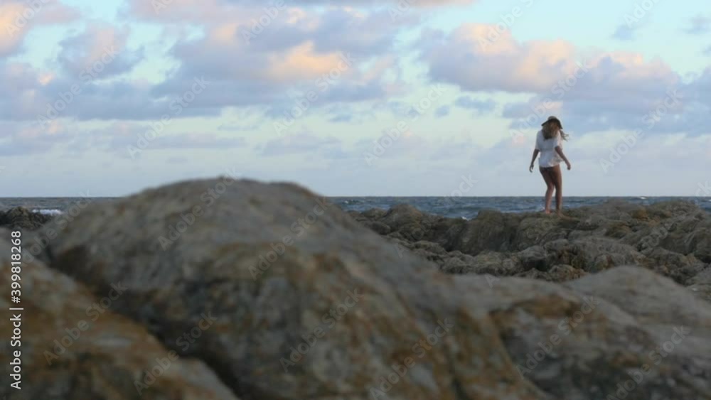 Girl waking on rocks by the sea. Slow motion HD 96fps Girl waking on rocks by the sea. Slow motion HD 96fps
