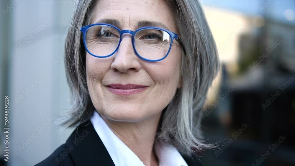 Closeup face of wrinkled mature woman, satisfied with her life, emancipation Closeup face of wrinkled mature woman, satisfied with her life, emancipation