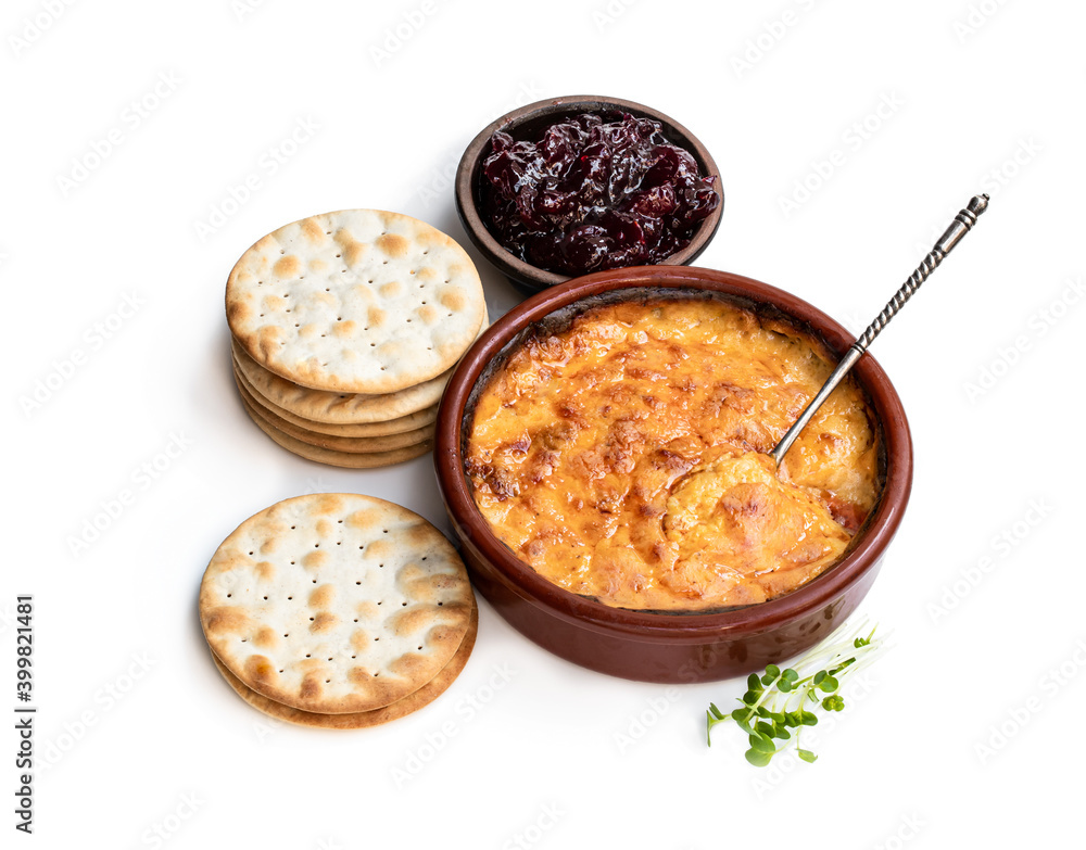 Baked mature cheddar cheese with spanish chorizo isolated on white