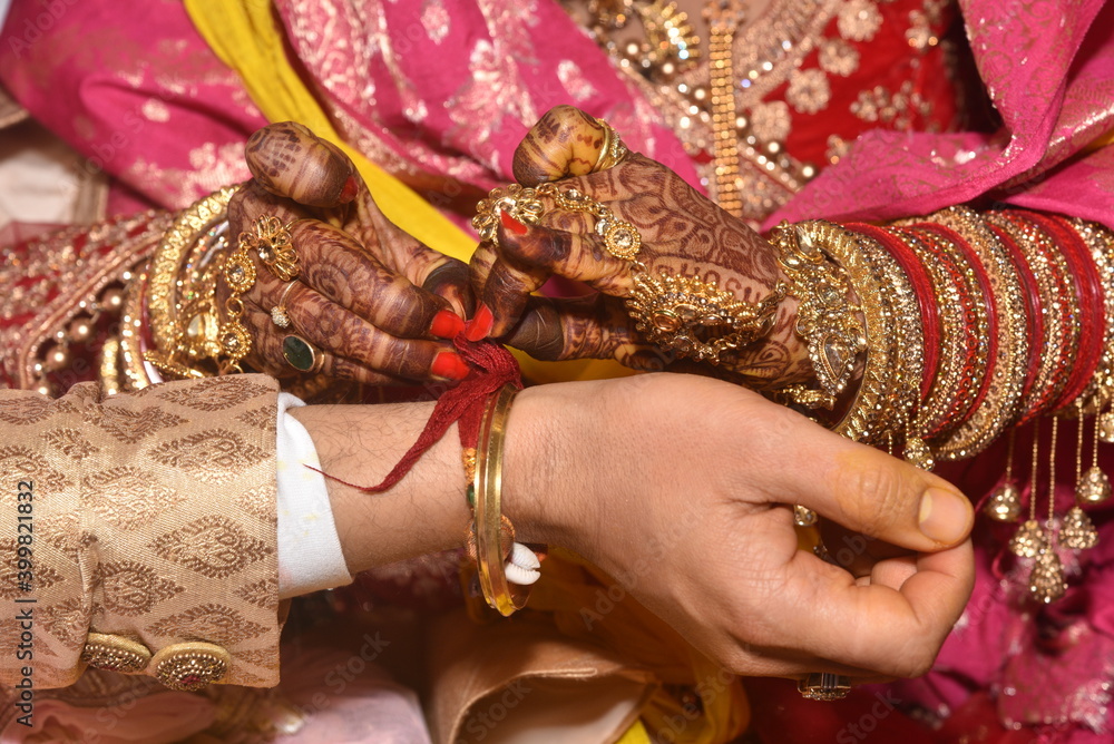 Kangna Ceremony during Indian Wedding. Bride tying knots during the wedding ceremony