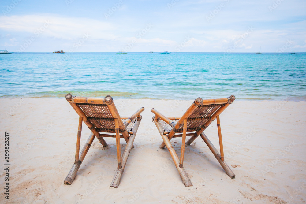 White lounge chairs on a beautiful tropical beach at Maldives White lounge chairs on a beautiful tropical beach at Maldives