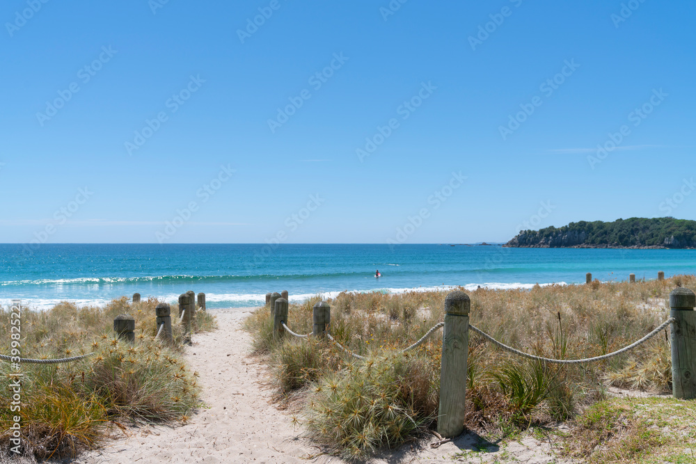 Bollards and ropes line sand track through dunes to Main Beach Mount Maunganui