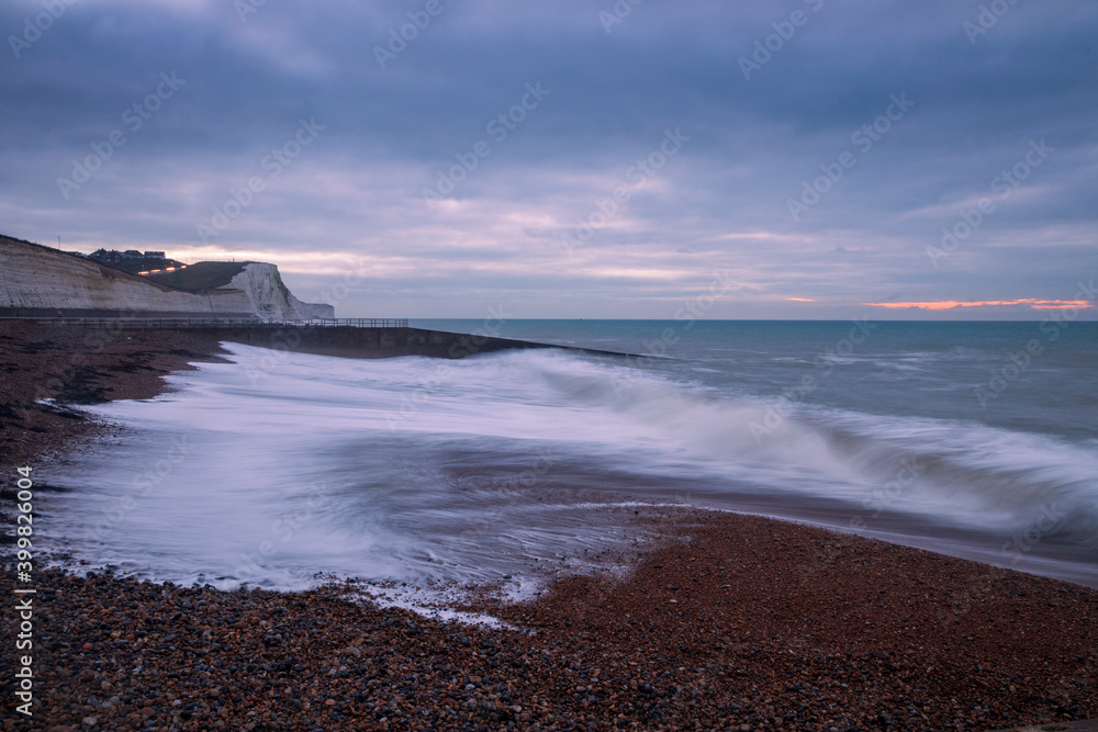 High tide at dawn on Saltdean beach near Brighton East Sussex south east England
