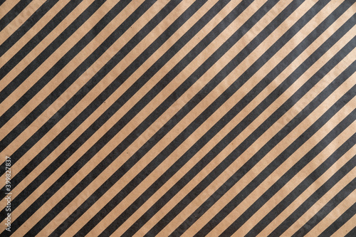 Black pattern stripe on brown paper background.
Diagonal landscape black pattern stripe on recycled  paper texture