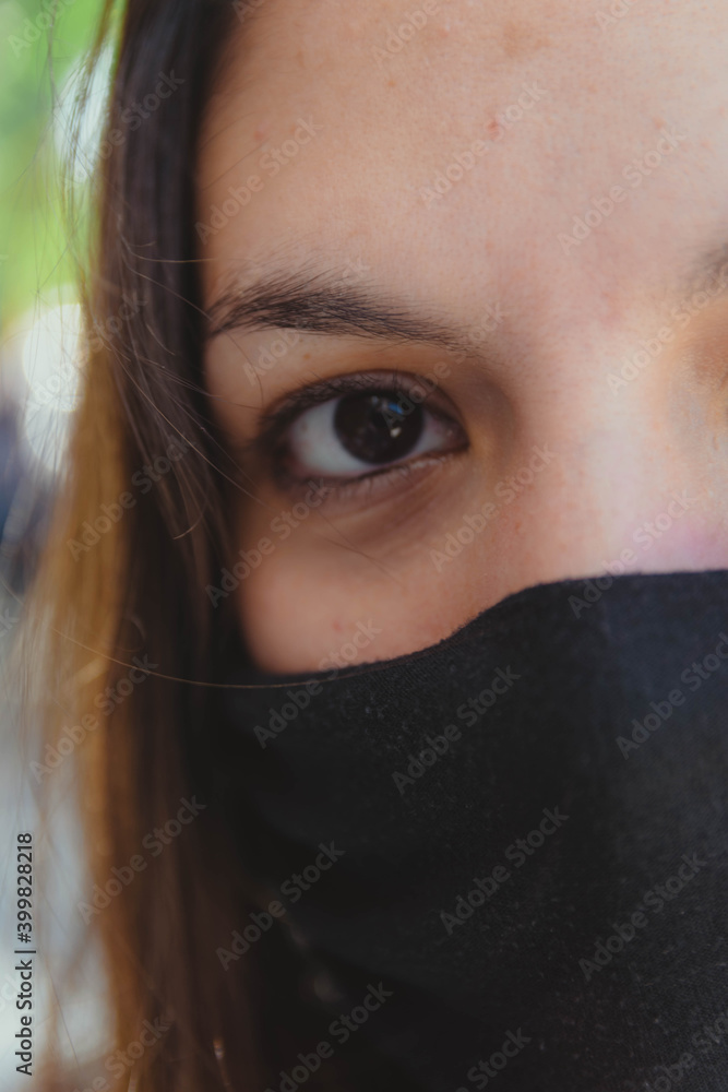 young woman outdoors facing the sun with chinstrap young woman outdoors facing the sun with chinstrap