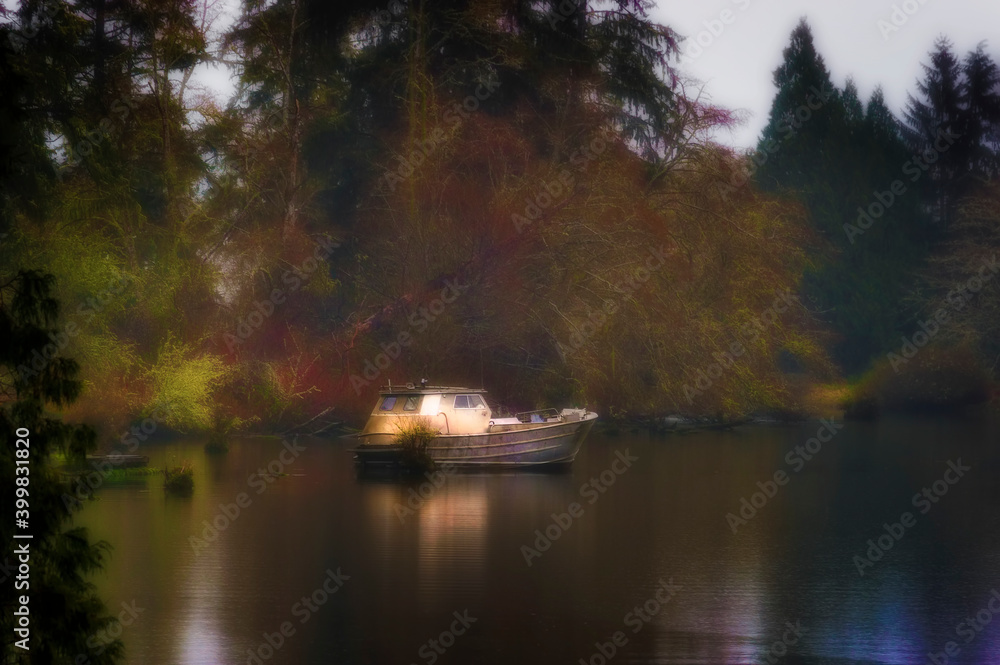 Boat sits in early evening light in misty weather.