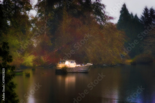 Boat sits in early evening light in misty weather.