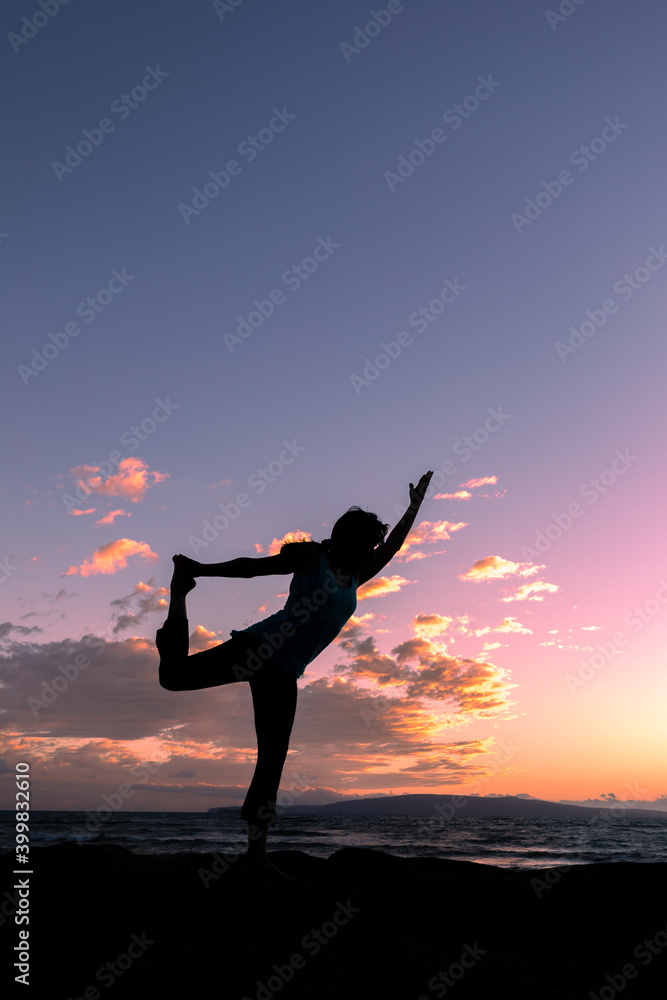Woman Practicing Yoga at Sunset on a Maui Beach