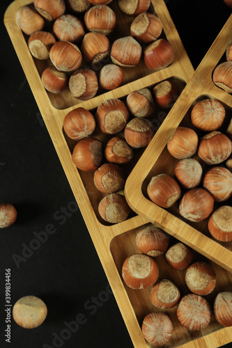 Hazelnuts on wooden backdrop. heap or stack of hazelnuts. healty food