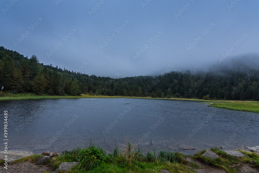 little mountain lake with dense rain clouds in the nature