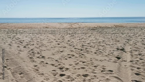 Beachfront beach empty of people and full of footprints