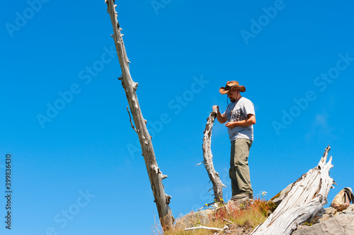 Hiker stands on top of Castle Peak