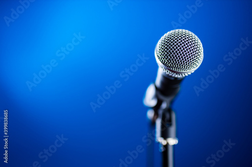 Microphone on stage against a background blue recording studio