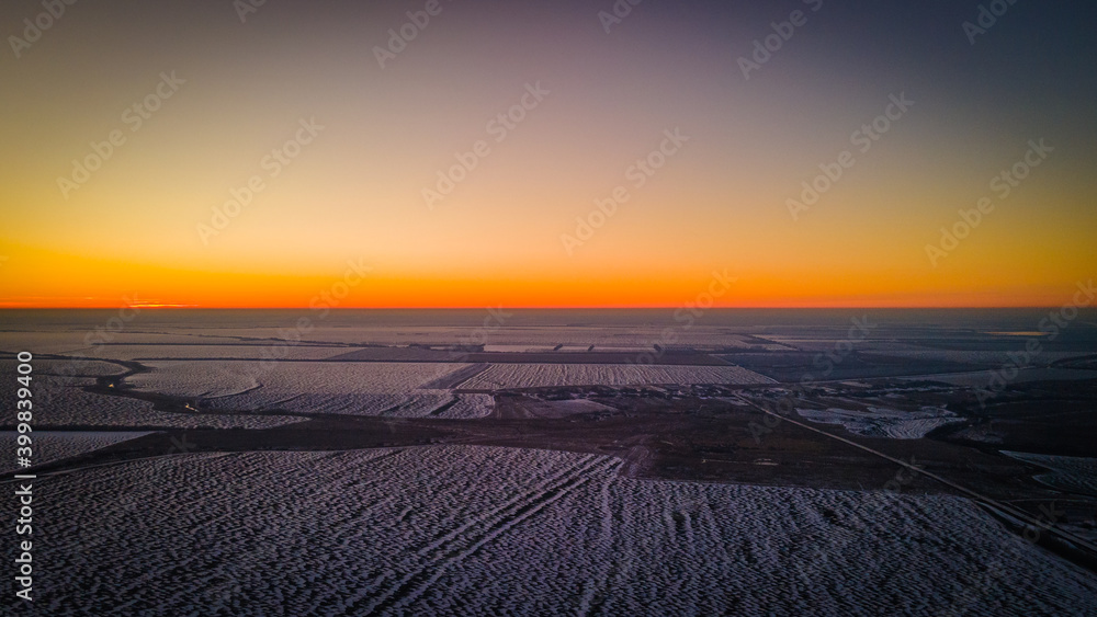 beautiful sunset in a winter frosty field