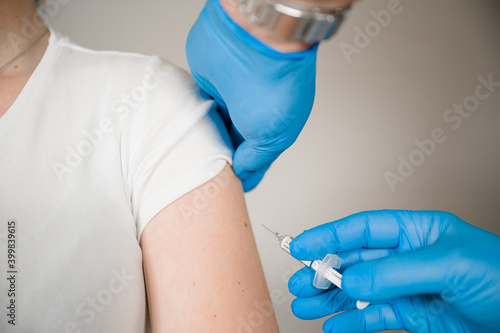 Doctor injecting Covid Vaccine into a patients arm  Curing the Corona Pandemic with mass Vaccination