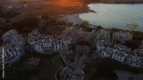 Aerial view during the sunset through the empty buildings of the abandoned hotel Costa del Croco, located near the seaside town of Tsarevo.