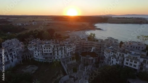 Aerial view during the sunset through the empty buildings of the abandoned hotel Costa del Croco, located near the seaside town of Tsarevo.