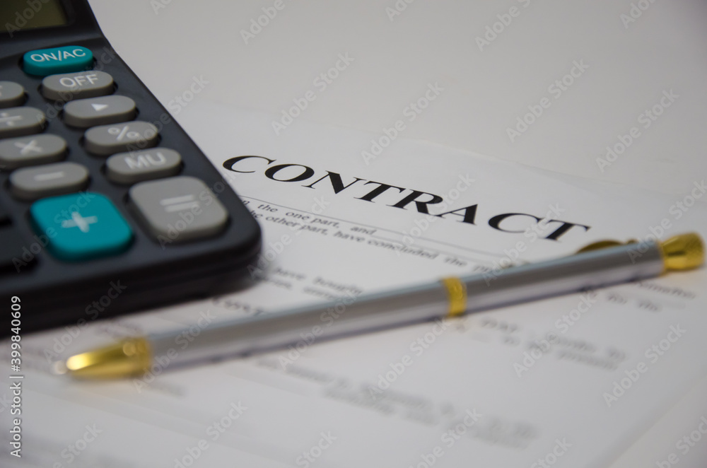 contract pen and calculator lie on a white background. sign contract. contract pen and calculator lie on a white background. sign contract.