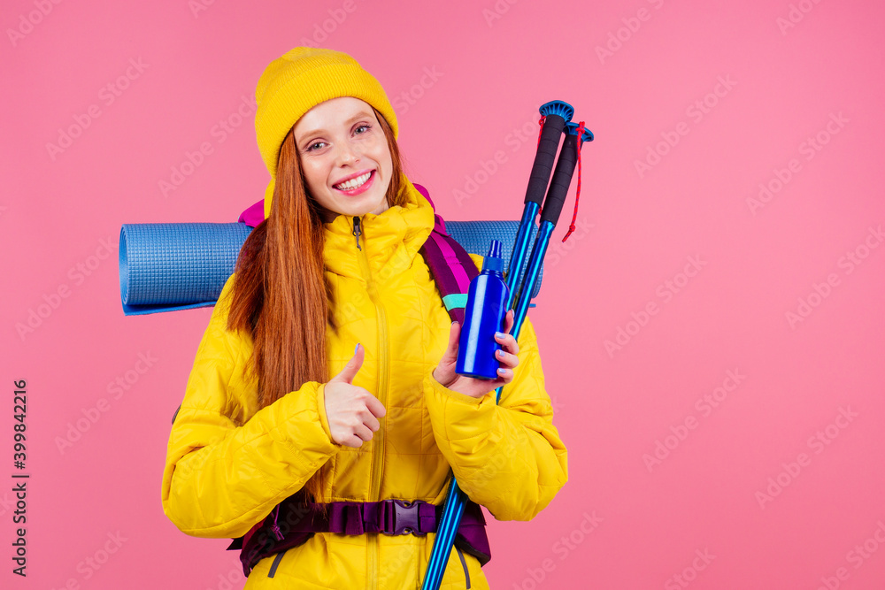 Happy woman ready to hiking in unknown place she is carries big backpack on shoulders in pink studio background Happy woman ready to hiking in unknown place she is carries big backpack on shoulders in pink studio background