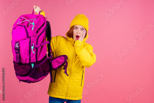 Tableau sur toile Happy woman ready for travel to mountains in new yellow jacket