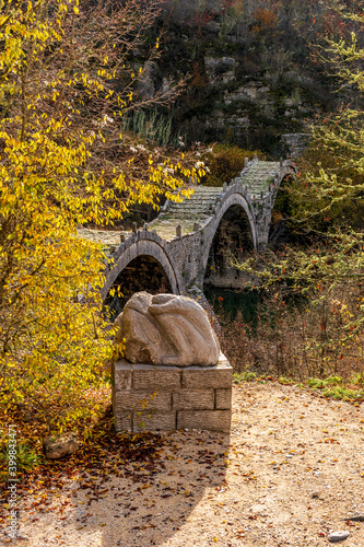 kalogeriko (plakida) old arch stone bridge during fall season  situated on the river of Voidomatis in  Zagori, Epirus Greece. photo