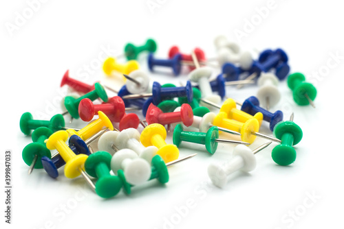 Closeup of colorful paper pins on white background