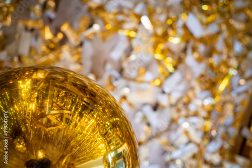 Christmas background, living branches of spruce. Christmas decorations, Santa's mitten Pink and gold balls and Christmas bells. Festive background.