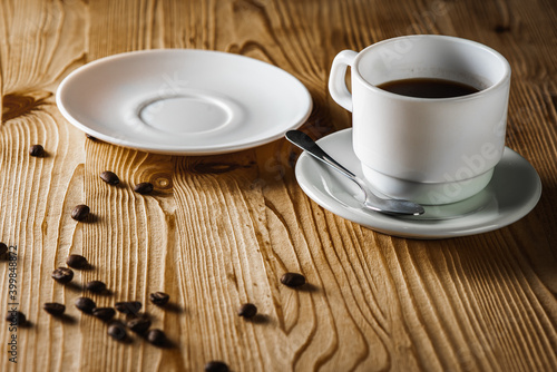 close up view, cup of white coffee with tea plates on wooden surface with space. Morning coffee concept