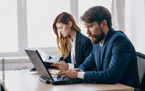 Business colleague at work at work desk laptop financial professionals