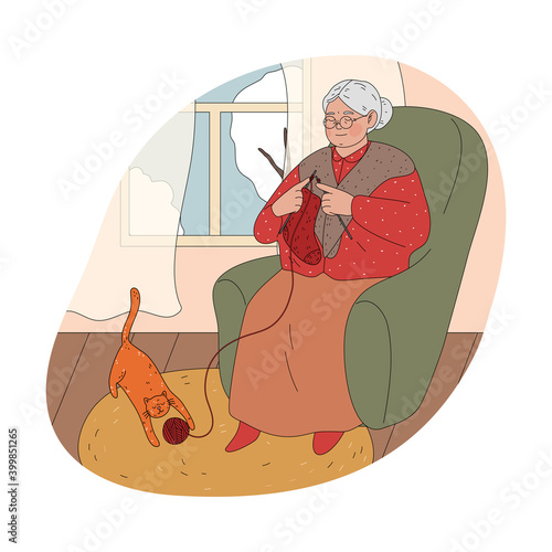Smiling ederly woman grandmother sitting in armchair at home and knitting