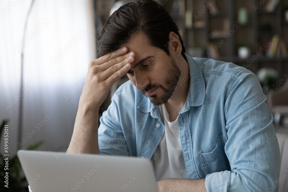 Pensive millennial male employee look at laptop screen thinking of problem solution. Thoughtful unhappy young Caucasian man work on computer have troubles on gadget, ponder or make decision. Pensive millennial male employee look at laptop screen thinking of problem solution. Thoughtful unhappy young Caucasian man work on computer have troubles on gadget, ponder or make decision.