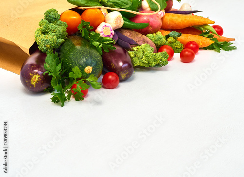 Vegetables in paper bag on white background.