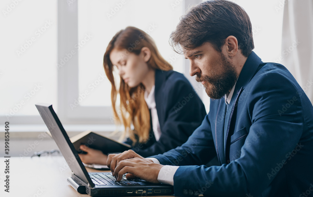 Work colleagues at office desk technology financial professional Work colleagues at office desk technology financial professional