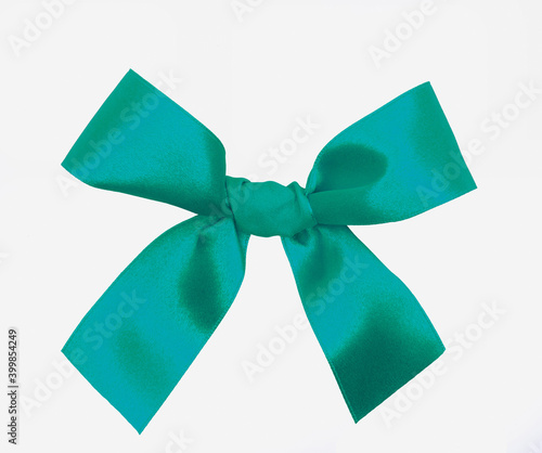 Turqouise blue and green ribbon bow for gifts to Christmas day celecration, surprise, close up view isolated on a white background
 photo