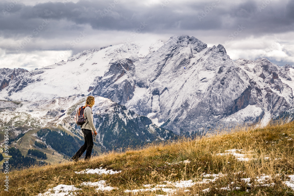 female hiker on trekking trail with snow covered mountains female hiker on trekking trail with snow covered mountains