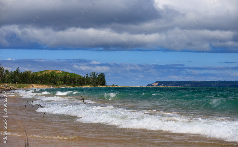 The shoreline of Lake Michigan, Blue skies, turquoise water, and clouds approaching The shoreline of Lake Michigan, Blue skies, turquoise water, and clouds approaching