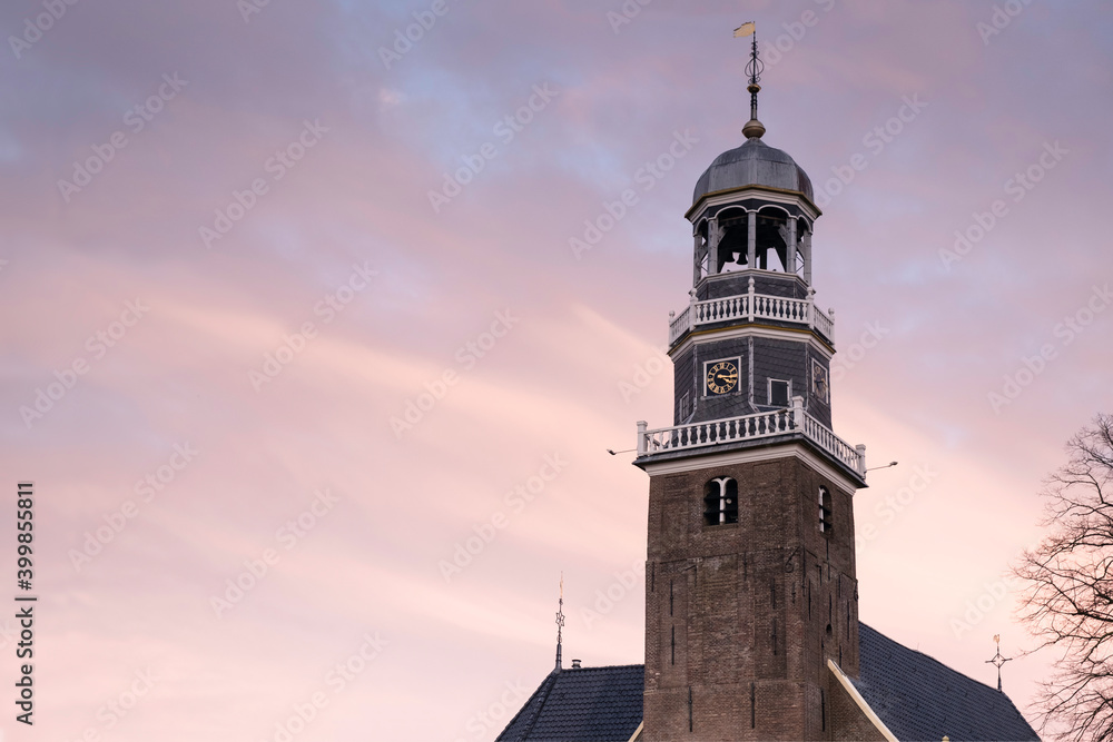 Tower of the reformed Church in the center of the village Lemmer at sunset in Friesland, The Netherlands Tower of the reformed Church in the center of the village Lemmer at sunset in Friesland, The Netherlands