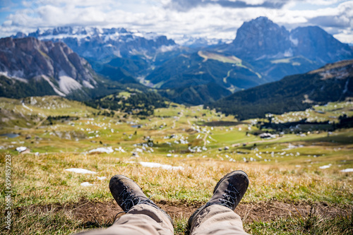hiker relaxing on medaow in the dolomites mountains