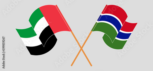 Crossed and waving flags of the United Arab Emirates and the Gambia