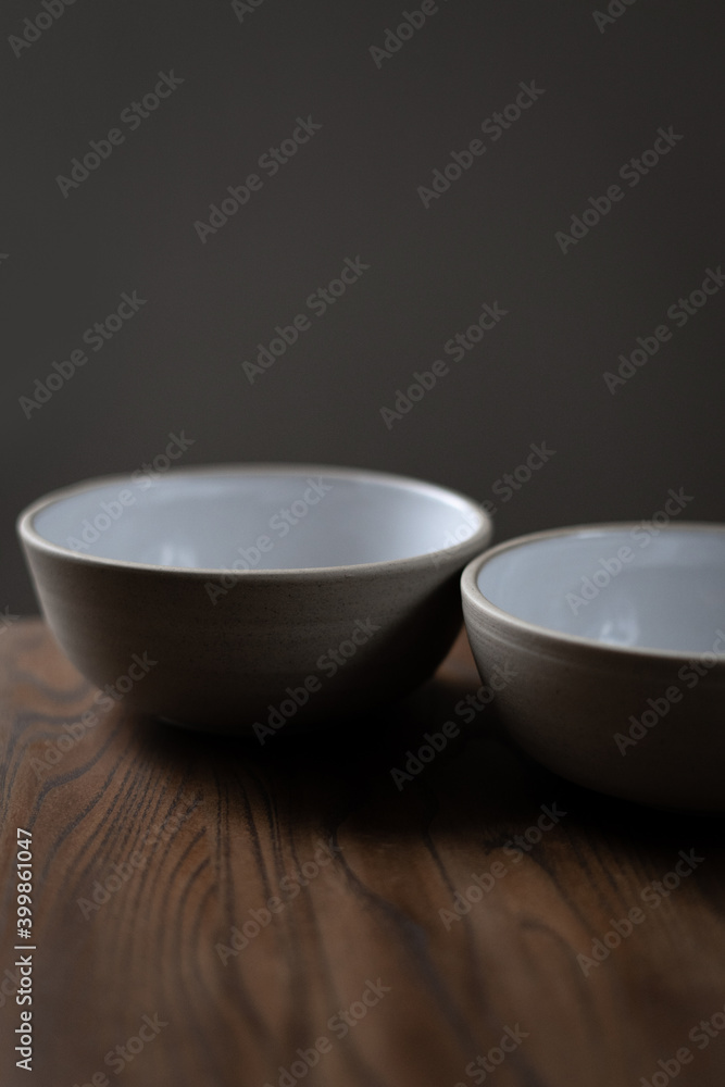 Empty ceramic bowl standing on wooden table Empty ceramic bowl standing on wooden table