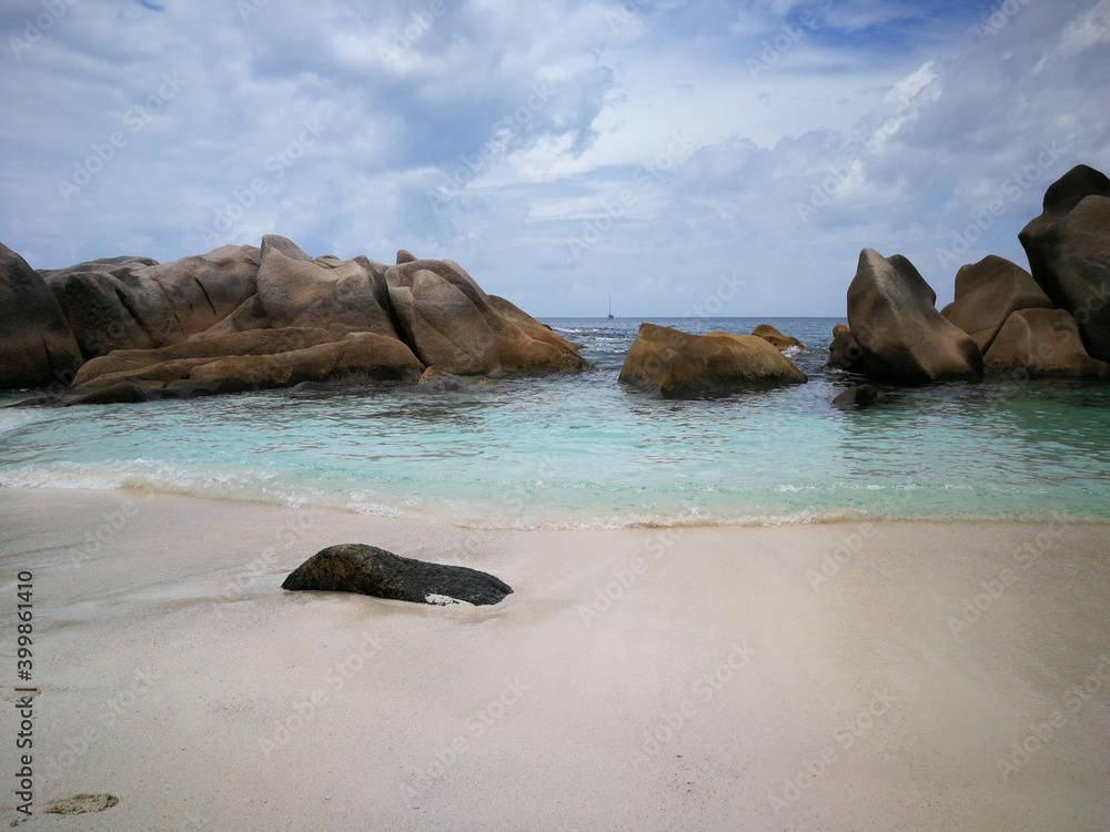 Fototapeta premium La Digue island beach with cliffs in Seychelles