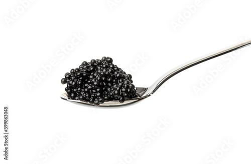 fresh grainy black paddlefish caviar in metal spoon isolated on white background