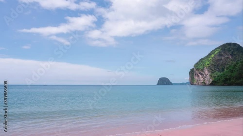 Timelapse of pinky sandy beach in smallisland, blue sky and white clouds moving over blue ocean water. Beautiful nature for holiday vacation in warm tropical country in paradise southern of Thailand photo